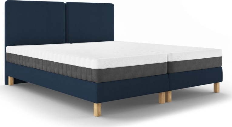 Tmavě modrá čalouněná dvoulůžková postel s roštem 180x200